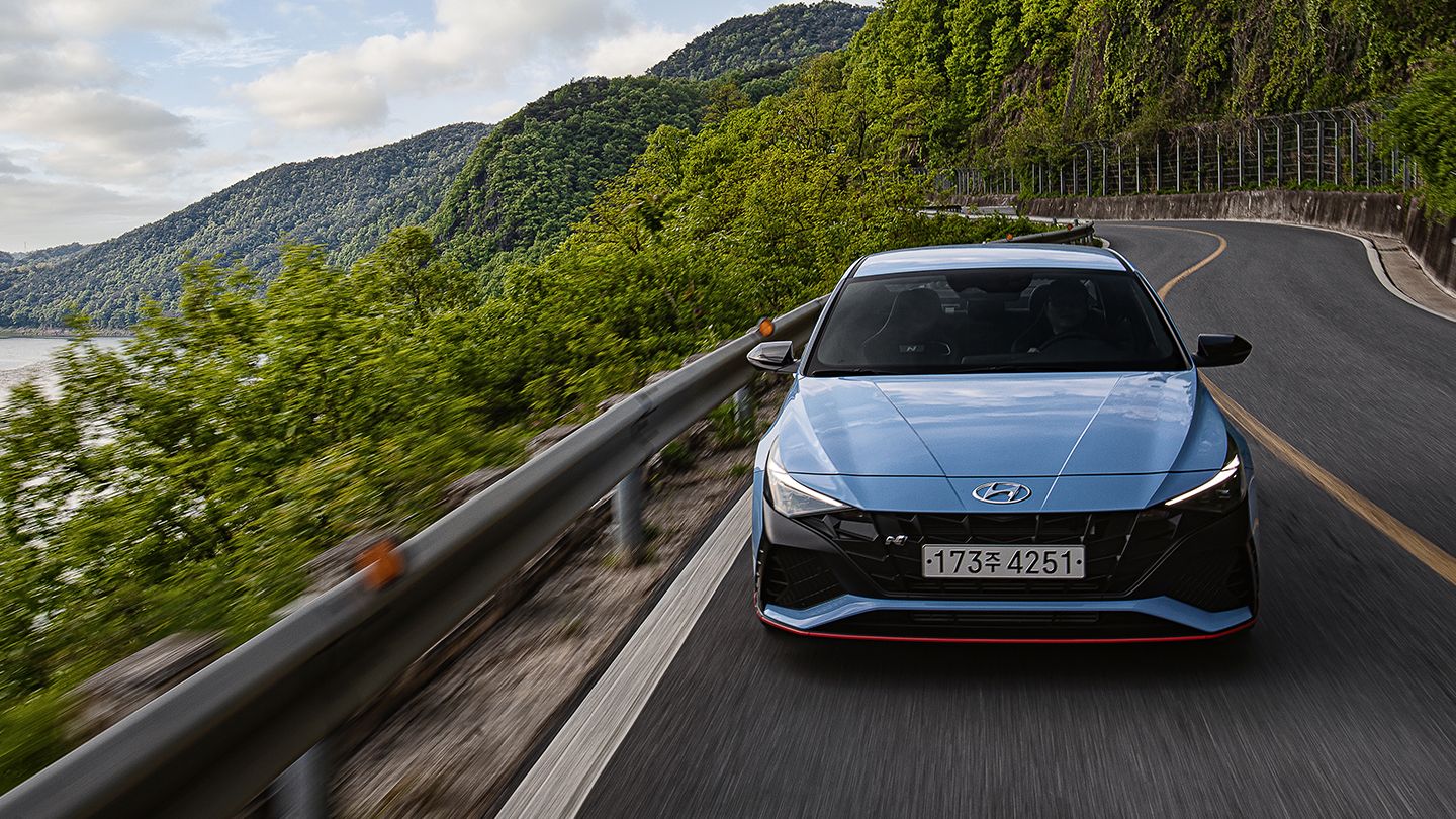Front view of Elantra N driving on a curved road