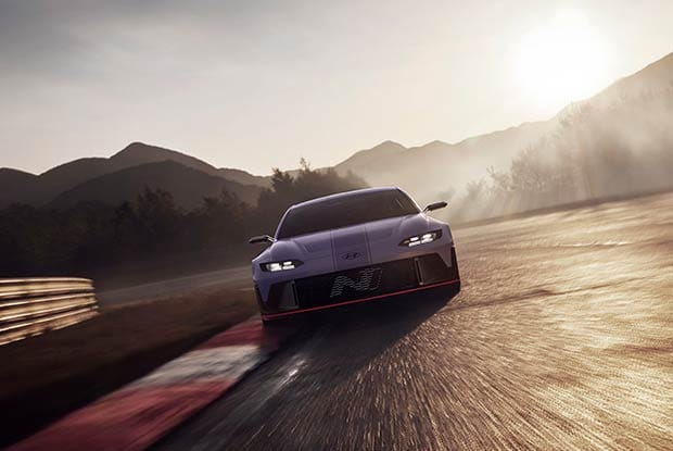 A high-performance Hyundai N vehicle driving on the track, showcasing its front view.