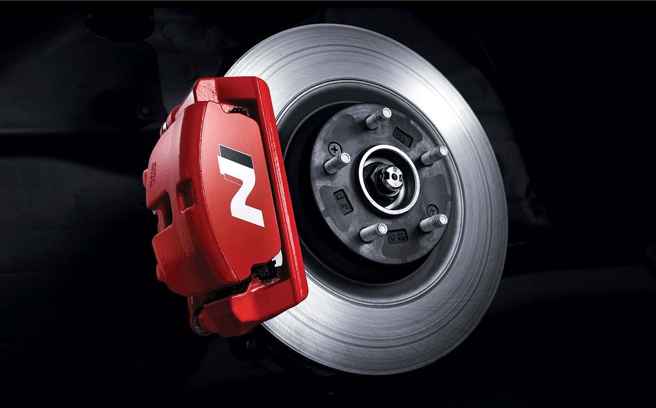 Brake caliper mounted on the car's wheel.