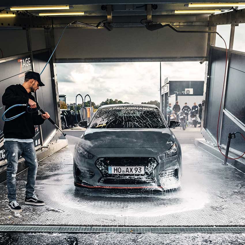 A man washing the car.