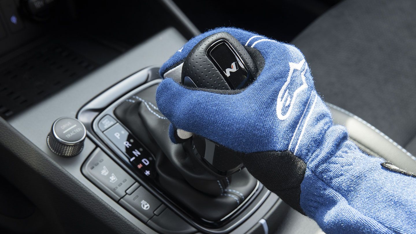 Driver’s hand gripping the gear shift.