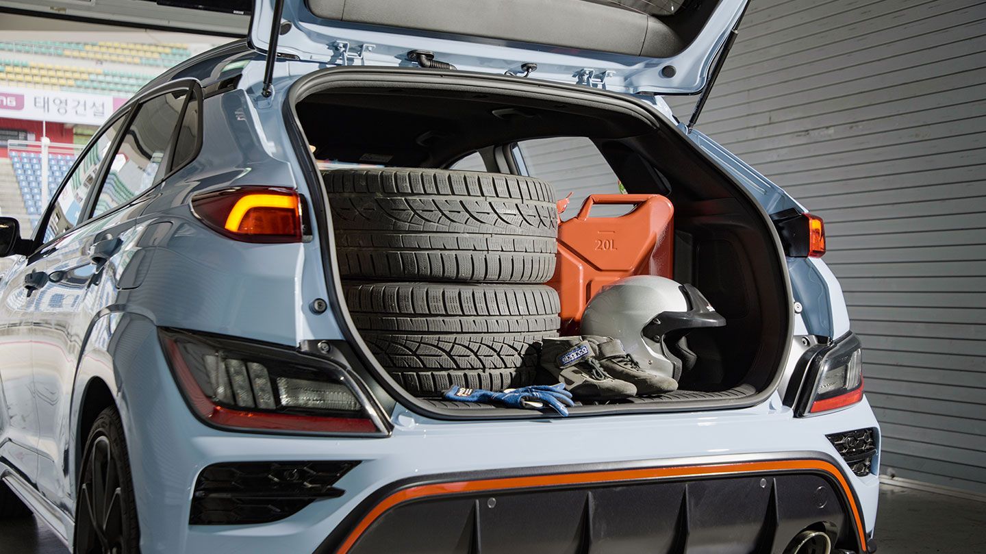 Trunk storing tires and track driving equipment.