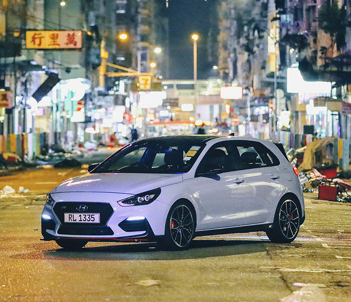 i30 N vehicle parked in front of Hong Kong night view background