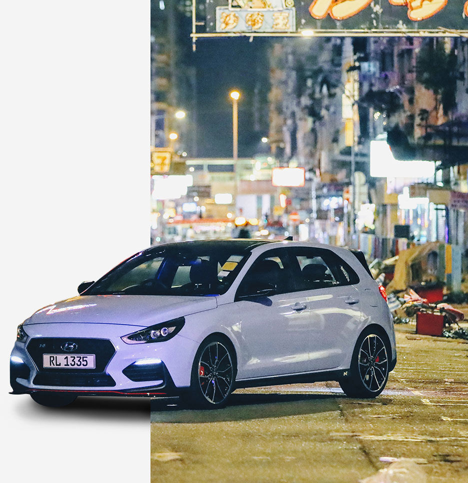 i30 N vehicle parked in front of Hong Kong night view background