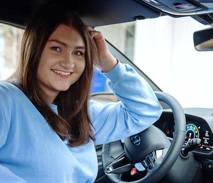 Nfluencer posing from the driver's seat of the I20 N toward the passenger seat