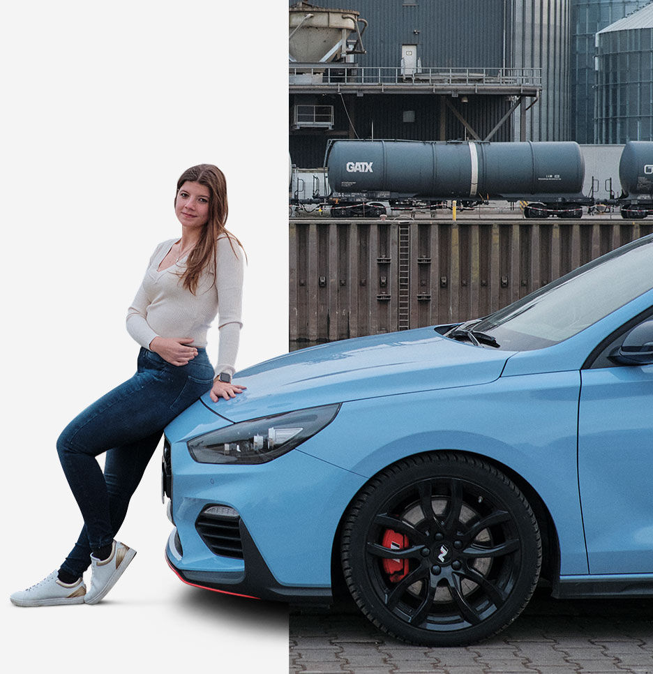Nfluencer posing on the bonnet of a side-parked car