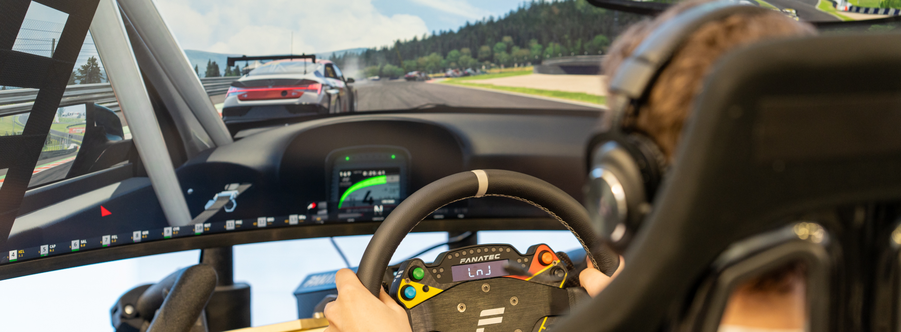 A player playing a game and the game screen using the game platform Assetto Corsa